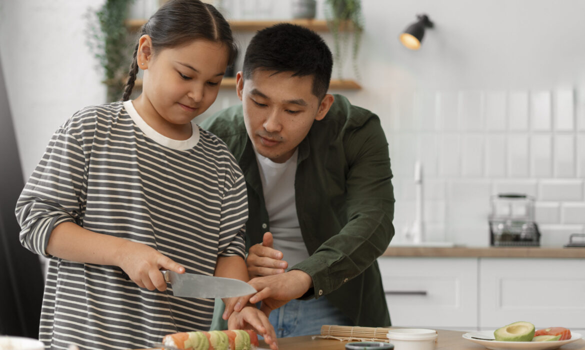 Teen learning to slice sushi rolls with guidance from an adult, representing life skills training for teens and young adults with autism.