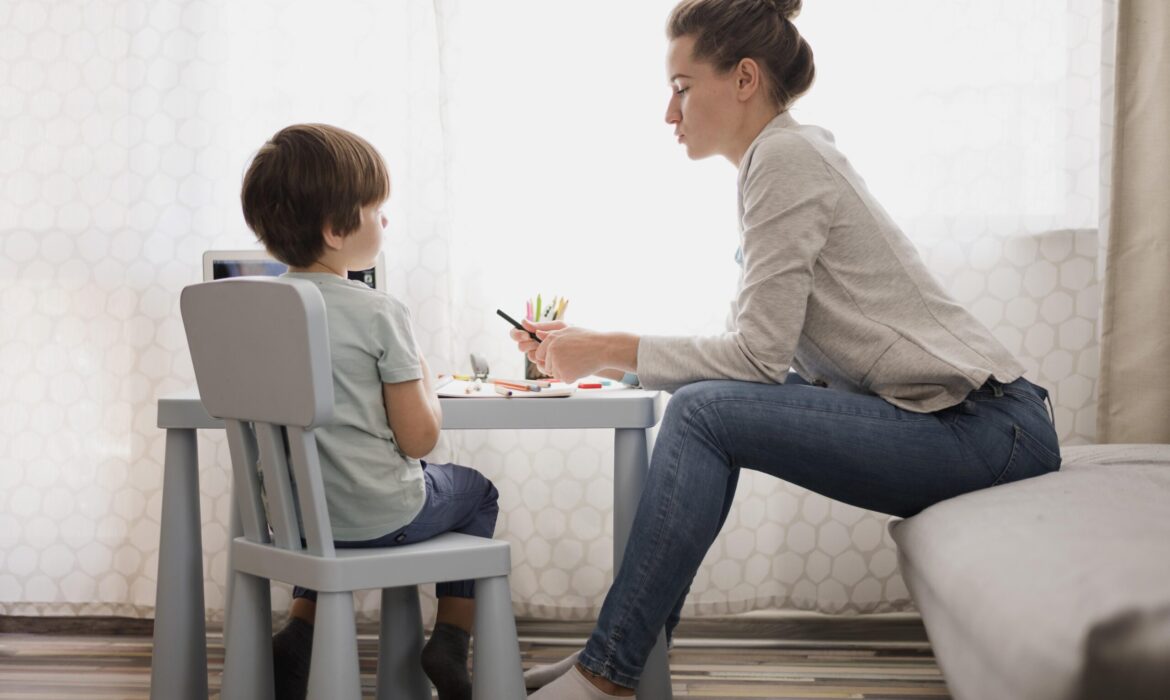 Therapist working one-on-one with a young child at a small table, engaging in activities that support development, symbolizing how therapy can nurture strengths and address challenges in autism.