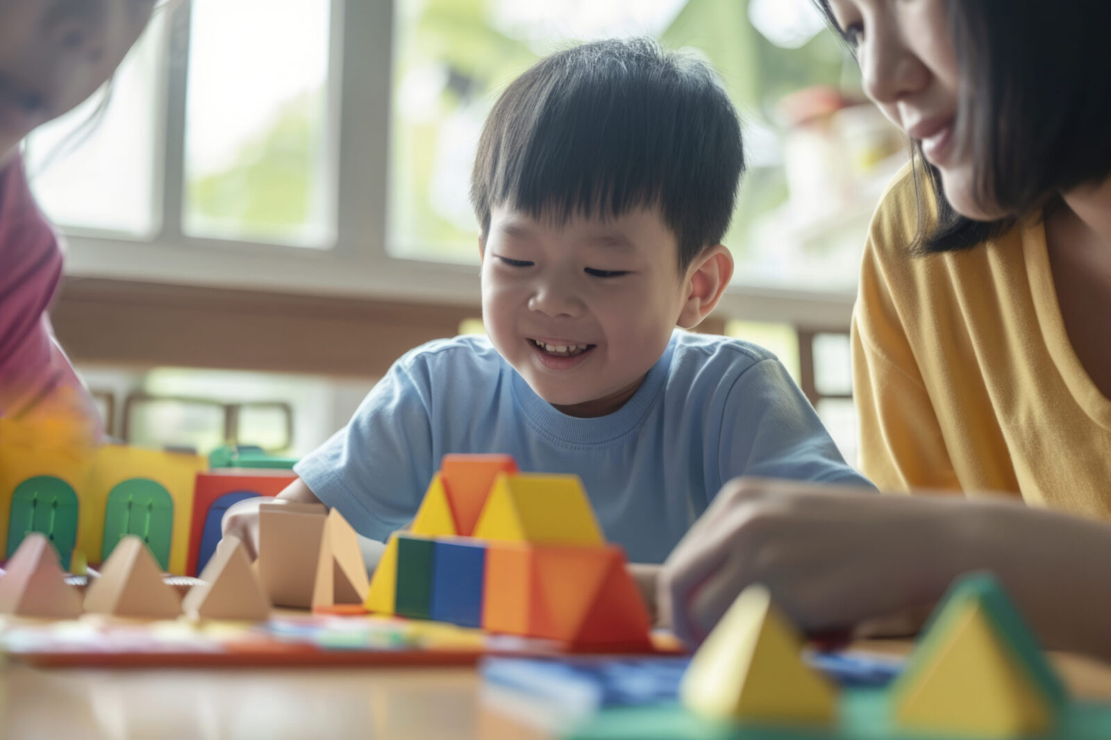 Smiling child engaging in a developmental activity with colorful blocks, illustrating the importance of tracking progress using an autism milestone chart.