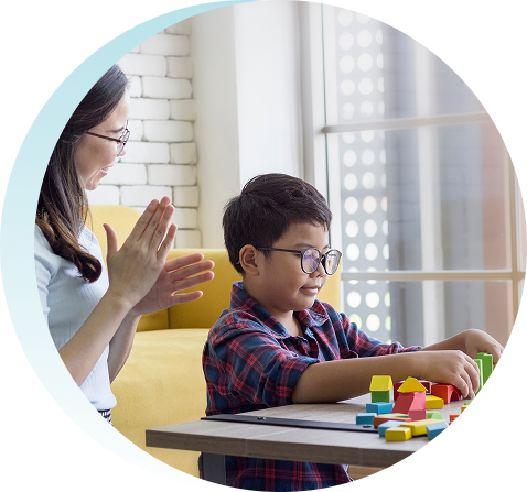 mother son sitting playroom playing wooden block game enjoying their time together