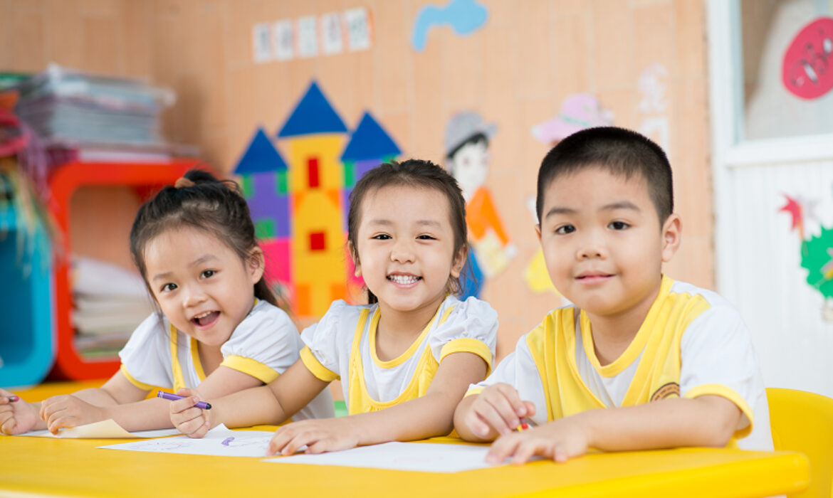Happy children learning in a supportive Singapore classroom environment.