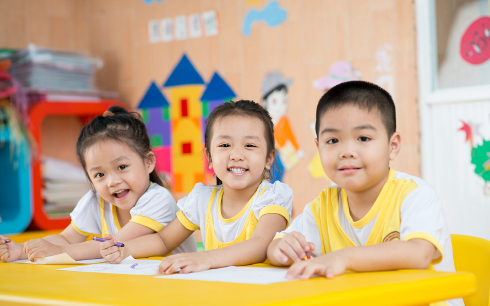 Happy children learning in a supportive Singapore classroom environment.