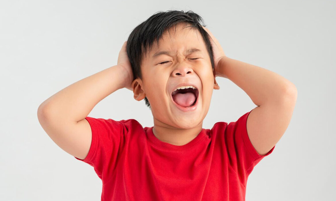 Child experiencing sensory overload and autism meltdown.