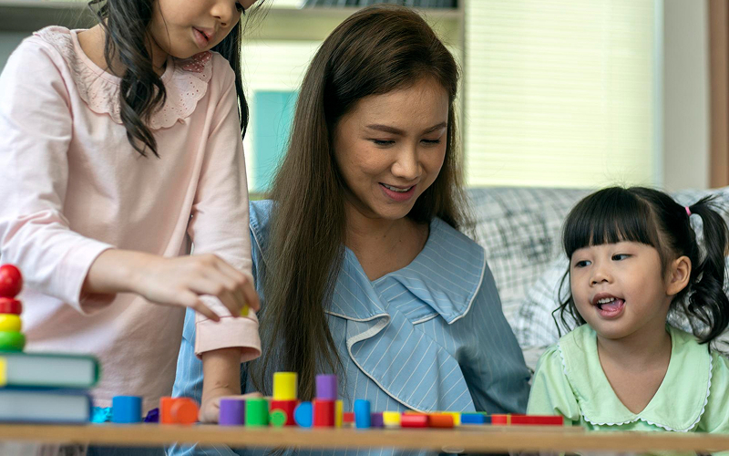 Child playing with blocks during a behavioral assessment session.